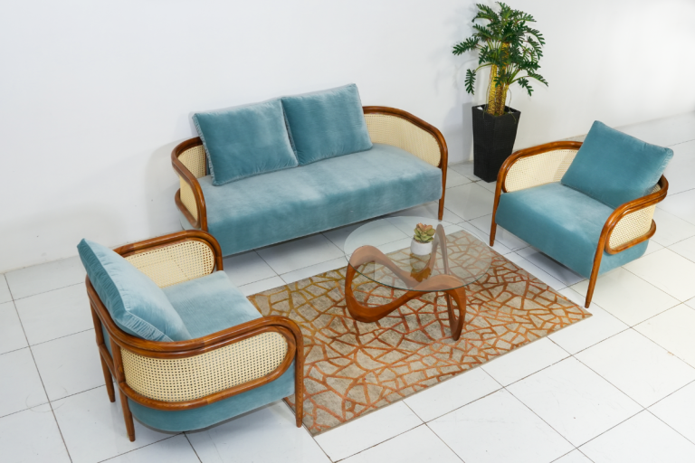Bộ sofa Themis gồm sofa băng ba và sofa đơn bọc vải xanh nhạt, khung gỗ bo cong kết hợp mây đan, bố trí trong phòng khách hiện đại.